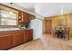 An efficient kitchen with ample cabinet space, a dining table and brick backsplash at 7390 Rafter Rd, Franktown, CO 80116