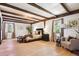 Bright main bedroom with exposed wood beams, hardwood floors, and neutral décor at 7390 Rafter Rd, Franktown, CO 80116