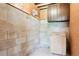 A storage room with concrete block walls, wood paneling, overhead lighting, and ample space at 7390 Rafter Rd, Franktown, CO 80116