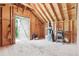 An open workshop with light wood features, tools, and an open door for natural light at 7390 Rafter Rd, Franktown, CO 80116