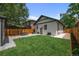 Large backyard featuring patio area, grassy area, and nice green lawn at 2569 Forest St, Denver, CO 80207