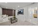 Bright basement living area featuring modern decor, carpet floors, and easy access to the bathroom at 2569 Forest St, Denver, CO 80207