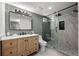 Contemporary bathroom featuring a wood vanity, marble countertop, sleek shower, and modern fixtures at 2569 Forest St, Denver, CO 80207