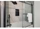 Contemporary bathroom with a tiled shower featuring a black rainfall shower head and built-in niche at 2569 Forest St, Denver, CO 80207