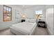 Bright bedroom with a neutral color palette, large windows, and stylish bedside tables at 2569 Forest St, Denver, CO 80207
