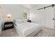 Minimalist bedroom featuring a queen bed, modern nightstands, and natural light from the window at 2569 Forest St, Denver, CO 80207