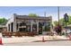 Exterior view of Long Table Brewhouse, featuring large windows, outdoor seating, and visible signage at 2569 Forest St, Denver, CO 80207