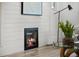 Contemporary fireplace design with shiplap and hardwood floors at 2569 Forest St, Denver, CO 80207