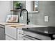 Close-up of a kitchen sink featuring a modern black faucet and countertop at 2569 Forest St, Denver, CO 80207