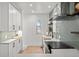 Modern kitchen featuring white cabinets, stainless steel appliances, and sleek countertops at 2569 Forest St, Denver, CO 80207