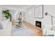 Open-concept living room featuring hardwood floors and a modern fireplace at 2569 Forest St, Denver, CO 80207