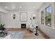 Cozy living room showcasing hardwood floors, fireplace, and windows at 2569 Forest St, Denver, CO 80207