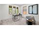 Bright home office with large windows, a modern desk, and comfortable seating area at 2569 Forest St, Denver, CO 80207