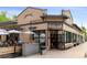 Exterior view of the Honey Hill restaurant featuring an outdoor patio and large open windows at 2569 Forest St, Denver, CO 80207