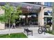 Exterior view of Sexy Pizza, featuring outdoor seating, a bicycle rack, and large windows at 2569 Forest St, Denver, CO 80207