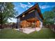 Expansive backyard featuring a patio, built-in fire pit, hot tub, and lush landscaping at 1490 S Vine St, Denver, CO 80210