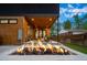 Backyard patio with a modern outdoor living space and wood ceiling overlooking manicured lawn at 1490 S Vine St, Denver, CO 80210