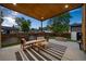 Backyard patio with cozy seating, fire pit, and view of a landscaped yard, perfect for outdoor gathering at 1490 S Vine St, Denver, CO 80210