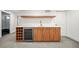 Modern basement bar with wood cabinets, wine fridge, quartz counters, and wood shelving for entertaining at 1490 S Vine St, Denver, CO 80210