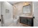 Modern bathroom featuring stylish tile work, a vanity, and a combined tub and shower at 1490 S Vine St, Denver, CO 80210