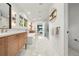 Bright bathroom featuring dual vanities, a soaking tub, walk-in shower, and modern fixtures at 1490 S Vine St, Denver, CO 80210