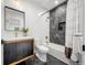 Modern bathroom featuring stylish tile work, a vanity, and a combined tub and shower at 1490 S Vine St, Denver, CO 80210