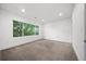 Empty bedroom with carpeted floors, a large window, and neutral wall colors at 1490 S Vine St, Denver, CO 80210