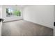 Empty bedroom with carpeted floors, a large window, and neutral wall colors at 1490 S Vine St, Denver, CO 80210