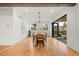 Dining area with modern light fixtures, hardwood floors, and view to outdoor patio at 1490 S Vine St, Denver, CO 80210