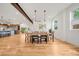 Dining area with modern light fixtures, hardwood floors, and view to the kitchen at 1490 S Vine St, Denver, CO 80210