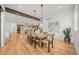 Dining area with modern light fixtures, hardwood floors, and view to the kitchen at 1490 S Vine St, Denver, CO 80210