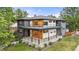 Modern two-story home with sleek gray siding, wood accents, and a second-story balcony at 1490 S Vine St, Denver, CO 80210