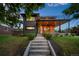Modern two-story home with sleek gray siding, wood accents, and a second-story balcony at 1490 S Vine St, Denver, CO 80210