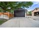 A detached two-car garage with a long driveway and wooden fence at 1490 S Vine St, Denver, CO 80210