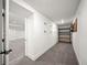Finished basement hallway leading to a storage area, painted in neutral color, and plush carpet at 1490 S Vine St, Denver, CO 80210