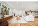 Bright living area with hardwood floors, fireplace, and open concept kitchen at 1490 S Vine St, Denver, CO 80210