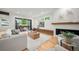 Bright living area with hardwood floors, fireplace, and access to the outdoor patio at 1490 S Vine St, Denver, CO 80210