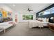 Spacious main bedroom with a seating area, accent wall, large windows, and plush carpeting at 1490 S Vine St, Denver, CO 80210