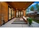 Outdoor patio with wood ceiling, sleek furniture, and views of the landscaped backyard at 1490 S Vine St, Denver, CO 80210
