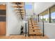 Modern staircase with wood steps, metal railings, and abundant natural light from large windows at 1490 S Vine St, Denver, CO 80210