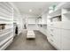 Spacious walk-in closet with custom shelving, drawers, and a central ottoman at 1490 S Vine St, Denver, CO 80210
