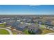 Aerial view of a neighborhood showcasing well-maintained homes and landscaping under a bright blue sky at 4316 Gypsum Ave, Mead, CO 80504