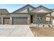 Charming exterior featuring stone accents, a covered porch, and a two-car garage at 4316 Gypsum Ave, Mead, CO 80504