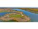 Scenic view of a community lake featuring an island with green spaces and walking paths at 4316 Gypsum Ave, Mead, CO 80504