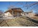 Spacious backyard showcasing a brick home addition with a covered patio and fenced area at 1376 S Zephyr Ct, Lakewood, CO 80232