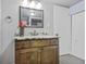 Charming bathroom with dark wood vanity, granite countertop, decorative mirror, and updated fixtures at 1376 S Zephyr Ct, Lakewood, CO 80232