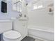 Bright bathroom featuring white tiled walls, a bathtub, and a stylish vanity with a mirror and storage at 1376 S Zephyr Ct, Lakewood, CO 80232