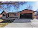 Front exterior of brick and siding home with two-car garage and wide driveway at 1376 S Zephyr Ct, Lakewood, CO 80232