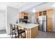 This kitchen features a breakfast bar, modern appliances, and stylish backsplash, perfect for casual dining and entertaining at 1376 S Zephyr Ct, Lakewood, CO 80232