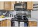 This kitchen features a modern oven and microwave, complemented by a stylish backsplash and ample storage at 1376 S Zephyr Ct, Lakewood, CO 80232